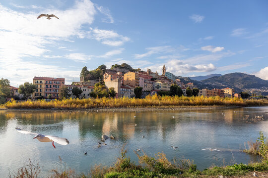 Old Residential Homes near river and sea in Ventimiglia, Italy. Sunny Fall Season.