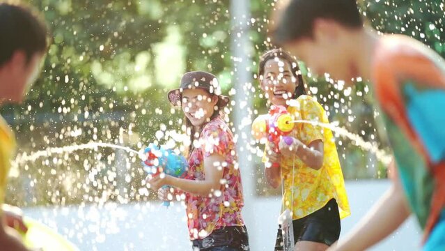 Asian people are using water guns play Songkran festival in the summer of April	
