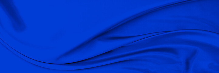 Black blue satin dark fabric texture luxurious shiny that is abstract silk cloth background with patterns soft waves blur beautiful.