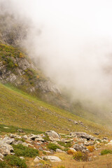 Mountain range with visible silhouettes through the morning colorful fog.