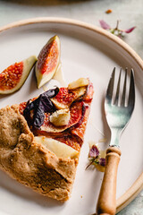 Homemade figs galette made with fresh organic figs, thyme, goats cheese on marble table