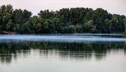 Obraz premium lake in the forest at sunset