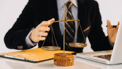 Business and lawyers discussing contract papers with brass scale on desk in office. Law, legal...