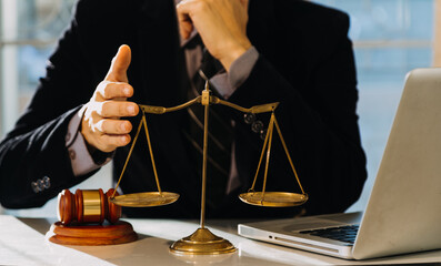 Business and lawyers discussing contract papers with brass scale on desk in office. Law, legal...