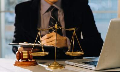 Business and lawyers discussing contract papers with brass scale on desk in office. Law, legal...