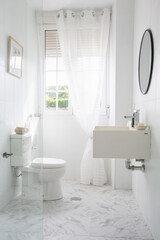 Fototapeta na wymiar Bathroom with toilet, sink, shower and round mirror in white