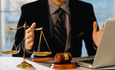 Business and lawyers discussing contract papers with brass scale on desk in office. Law, legal...