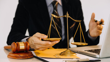 Business and lawyers discussing contract papers with brass scale on desk in office. Law, legal...
