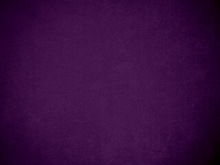 Dark purple velvet fabric texture used as background. Tone color purple cloth  background of soft and smooth textile material. There is space for text and for all types of design work..