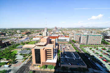 Panoramic aerial northbound view of Downtown Phoenix, Arizona, showcasing buildings, parking lots, streets and vehicles