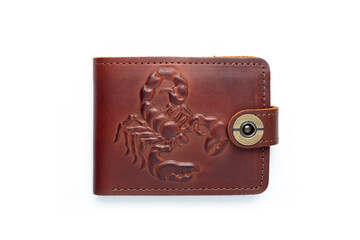 Brown leather wallet on a button on a white background, scorpion print. Top view