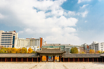 Entrance gate of Changygeonggung palace with the modern buildings of Seoul in the background, South Korea, Asia