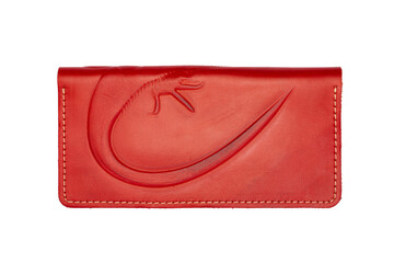 Big red leather wallet on a button on a white background, iguana print. Top view