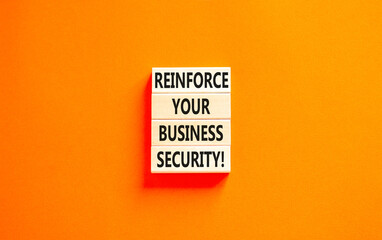 Reinforce your business security symbol. Concept word Reinforce your business security on blocks. Beautiful orange table orange background. Business reinforce business security concept. Copy space.
