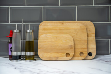 glass bottles with pouring spouts for olive oil balsamic vinegar with bamboo boards on granite...
