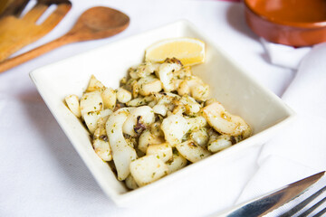 Puntas de calamar al ajillo. Grilled squid tips with garlic. Traditional Spanish tapa.