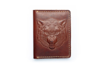 Brown leather wallet on a button on a white background, wolf print. Top view
