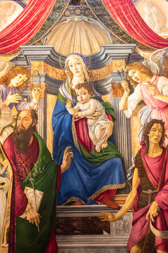 Medieval painting showing Virgin Mary on a throne holding baby Jesus and surrounded by angels and saints