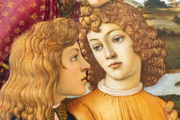 Close-up on medieval painting showing the faces of twin blond boys