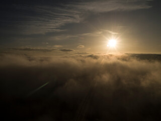 Sun Rise Through CloudsAn Orange Sun Rise bursts Through Clouds