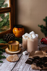 glass with hot chocolate and marshmallows and gingerbread cookie