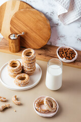 milk in a glass and bagels in glaze on the background of a marbl