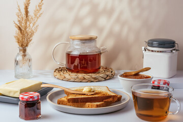 toast with butter on a plate and tea in a cup