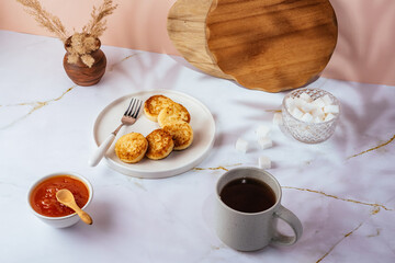 cottage cheese pancakes on a plate, tea, honey. breakfast