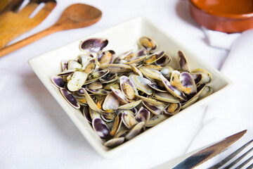 Clams tapa cooked with garlic, oil and white wine. Traditional Spanish tapa recipe.