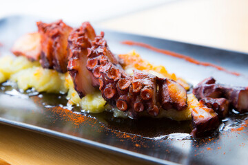 Pulpo a la Gallega. Octopus cooked with boiled potato, paprika and olive oil. Galician octopus...