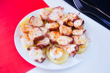 Pulpo a la Gallega. Octopus cooked with boiled potato, paprika and olive oil. Galician octopus recipe north of Spain tapa.