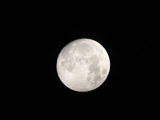 Naklejka premium Telescopic view of a full moon. Full moon shot showing details of the moon s surface.