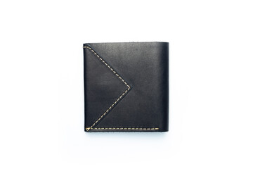 Small black leather wallet on a button on a white background. Top view