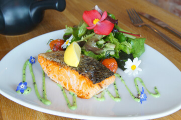 Baked salmon with vegetables and salad.