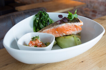 Baked salmon with vegetables and salad.