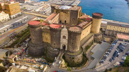 Papier Peint photo autocollant Naples Aerial view of Castel Nuovo often called Maschio Angioino, a medieval castle located on the seafront, in the historic center of Naples, Italy. It was a royal seat for the kings of Naples and Aragon.