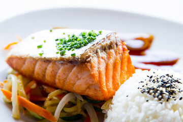 Baked salmon with vegetables and salad.