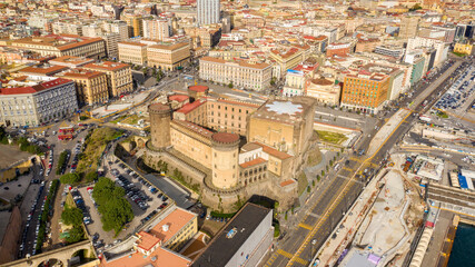 Aerial view of Castel Nuovo often called Maschio Angioino, a medieval castle located on the seafront, in the historic center of Naples, Italy. It was a royal seat for the kings of Naples and Aragon. - obrazy, fototapety, plakaty