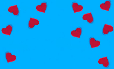 Red hearts on the blue background. Copy space. Holiday background.
