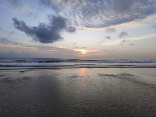 sunset reflections on the beach. sky reflections on the water. goa beach.