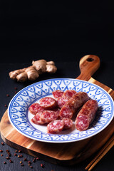 Food concept Sweet Chinese sausage Lap cheong in asia style plate on wooden board with copy space