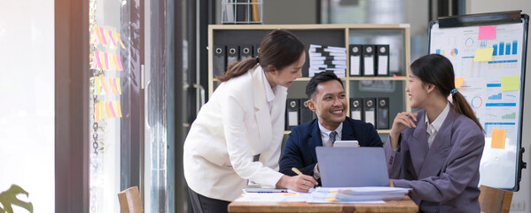 Group of young asian modern people in smart casual wear having a brainstorm meeting. Group of young asian business people discussing in the meeting. © wichayada