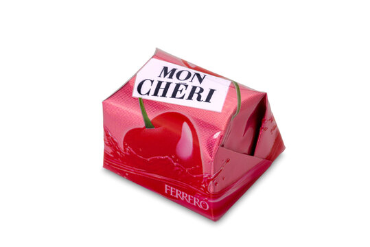 Alba, Italy - January 04, 2023: Mon Cheri Ferrero dark chocolate filled with liqueur and cherry in syrup, close up isolated on white, clipping path included