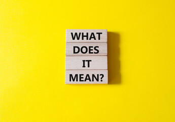 What does it mean symbol. Wooden blocks with words What does it mean. Beautiful yellow background. Business and What does it mean concept. Copy space.