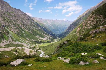 Fototapeta na wymiar Scenery of Tian Shan Mountains during trekking in Altyn Arashan Valley to beautiful glacier. Karakol national park. Kyrgyzstan, Central Asia