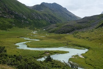 Scenery of Tian Shan Mountains during trekking in Altyn Arashan Valley to beautiful glacier....