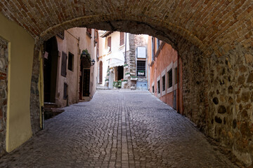 Fototapeta premium view through door with stone wall and path 