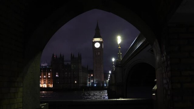 Landmark 4K video with Big Ben clock tower after renovation. Night landscape photo in London under the Westminster bridge during a rainy cloudy evening. Travel to England.