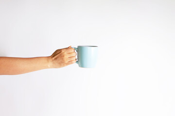 hand of young girl holding blue cup isolated on white background