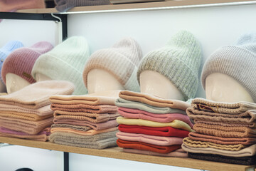 Showcase of trade tent with variety of women's hats for the autumn and winter seasons - knitted...